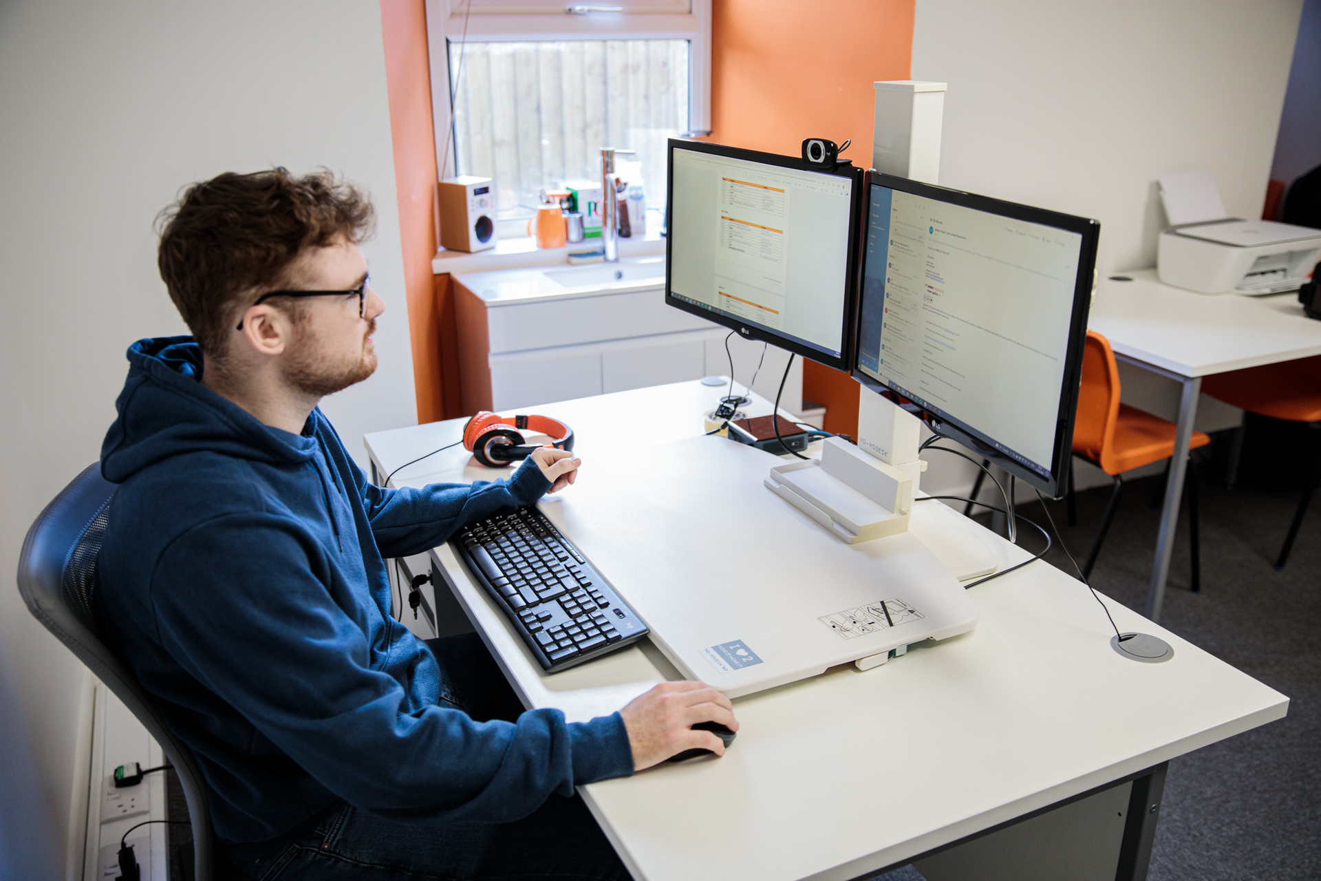 A social media executive working on his desktop computer in an office